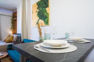 a kitchen with a table with plates and bowls on it at ILIRIA Apartment in Durrës