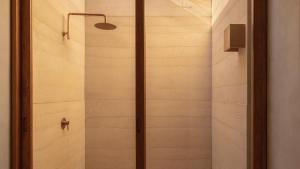 a shower with a glass door in a bathroom at Salara Boutique Hotel & Villas Todos Santos in Todos Santos