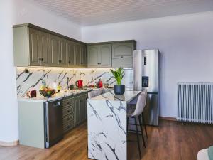 a kitchen with green cabinets and a refrigerator at Marilion Villa in Ioannina