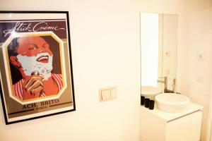 a bathroom with a poster of a woman holding a microphone at Oporto Chic&Cozy - Batalha in Porto
