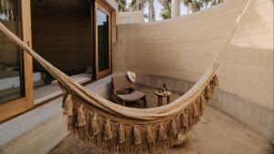a hammock on a porch of a house at Salara Boutique Hotel & Villas Todos Santos in Todos Santos