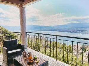 a balcony with a table and a chair and a view at Marilion Villa in Ioannina