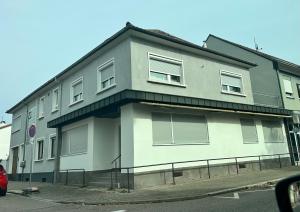 a building on a street with a car parked in front at Gästezimmer Kirrlach in Waghäusel