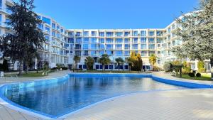 a large swimming pool in front of a building at Atlantis Resort Nikol in Burgas