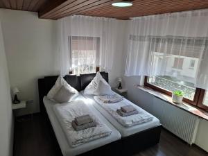 a bedroom with a bed with two pillows on it at Ferienhaus Richard in Eschwege