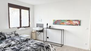 a white bedroom with a bed and a sink at Gästezimmer Kirrlach in Waghäusel