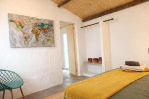 a bedroom with a map of the world on the wall at Encanto do frade in Carrapatelo +19 photos
