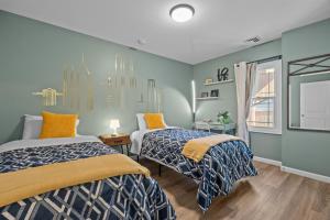 two beds in a room with blue walls at Kayaks & River Access Easy Parking Beautiful in Gladwyne +29 photos