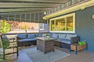a patio with a blue couch and a table at Kayaks & River Access Easy Parking Beautiful in Gladwyne