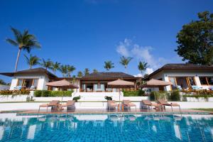 a pool at a resort with chairs and umbrellas at Baan Apsara - Stunning Sea View 3 Bed Pool Villa in Choeng Mon Beach