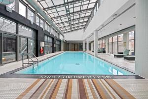 a large swimming pool in a building at Stylish 2BR Downtown Sanctuary - Free Parking in Toronto