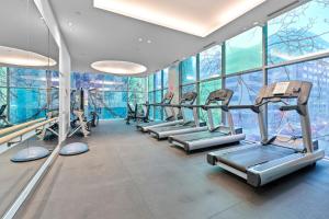a gym with a row of treadmills and ellipticals at Stylish 2BR Downtown Sanctuary - Free Parking in Toronto