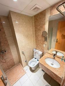 a bathroom with a toilet and a sink and a shower at Etqan Al Mashair Two in Mecca +17 photos