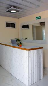 an office with a counter with a laptop on it at Hotel ALCALA in Mingueo +15 photos