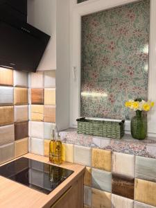 a kitchen with a sink and a tile wall at Федорцьо in Mukacheve +31 photos