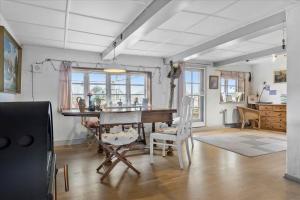a living room with a wooden table and chairs at Ferienhaus Sommer in Nordborg