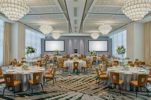 a ballroom with tables and chairs and projection screens at Brickell Arch, a Luxury Collection Hotel, Miami in Miami +28 photos