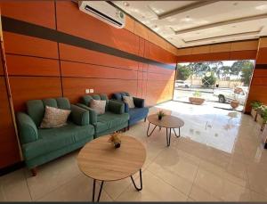 a living room with a couch and two tables at شقق تبيان سويت للشقق المخدومة الفرع الاول in Ar Ruwanah +2 photos