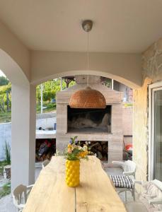 a dining room with a table and a fireplace at House Joie in Blaguša