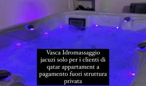 a purple bathtub with a sign in front of it at Qatar Apartment in Cosenza