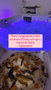 a pizza sitting in a box in a bath tub at Qatar Apartment in Cosenza
