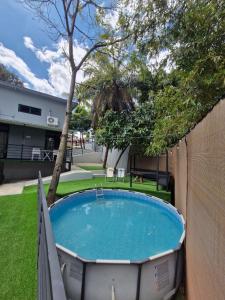 a hot tub in a yard with a fence at Casabela in Comayagua