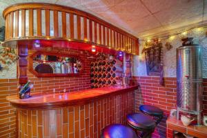 a bar in a restaurant with red brick walls and stools at Forest Retreat Bonidesa - Terrace & Jacuzzi - Happy Rentals in Ljubno