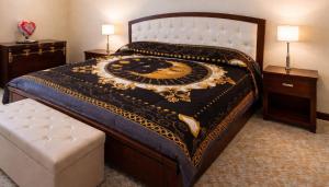 a bedroom with a large bed and two night stands at Nino's House in Sperlinga