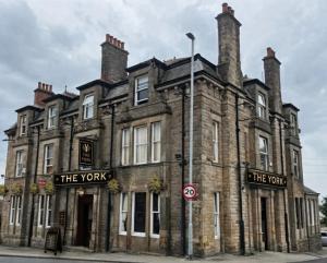 a large brick building with two chimneys on top at THE YoRK in Morecambe