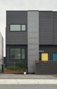 a black building with a sign on the side of it at Modern House with Aurora Views in Yellowknife