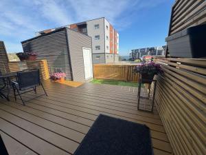 a wooden deck with a table and chairs on it at Modern House with Aurora Views in Yellowknife