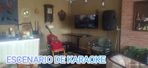 a living room with a guitar and a tv at Hospedaje La Tuna in Rocha +15 photos
