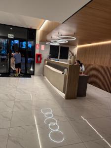 a lobby with a counter and people in a building at Miraflores Loft Piscina in Lima +31 photos
