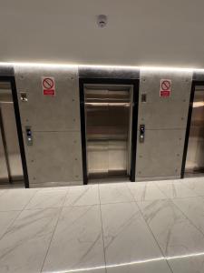a row of elevator doors in a building at Miraflores Loft Piscina in Lima