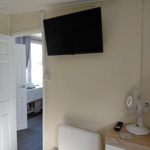 a flat screen tv on the wall of a room at 18 Sea Valley Bideford Bay Park Dean in Bideford