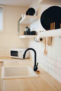 a kitchen counter with a sink and a microwave at California Suite in Fort Saint John