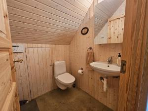 a small bathroom with a toilet and a sink at Secret lagoon cabin in Fludir