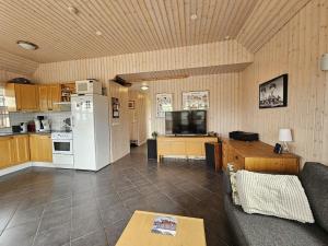 a kitchen and living room with a white refrigerator at Secret lagoon cabin in Fludir