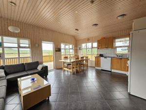 a living room with a couch and a table at Secret lagoon cabin in Fludir +21 photos