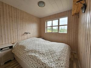 a bedroom with a bed and a window at Secret lagoon cabin in Fludir