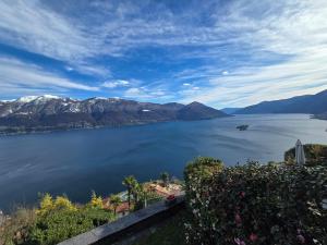 a view of a large body of water with mountains at Casa Rocca Nera by HolAp in Ronco sopra Ascona