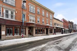 an empty street in a city with buildings at Condo St-Roch in Quebec City
