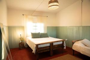 a bedroom with a bed with two pillows on it at Casa Cosmos in Colonia Ayui +13 photos