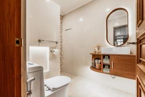 a bathroom with a toilet and a sink at Sakabumi Home in Ngabean +2 photos
