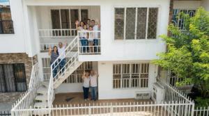 a group of people standing on the stairs of a building at Mom's House Floralia in Cali