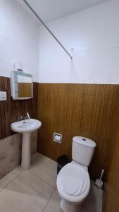 a bathroom with a white toilet and a sink at Yellowkits in São Paulo
