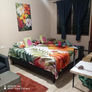 a large bed with colorful sheets in a room at Hitimahana lodge in Fare