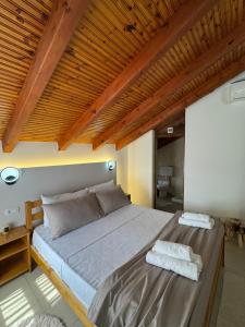 a bedroom with a large bed with two towels on it at Blessed guest house in Shkodër