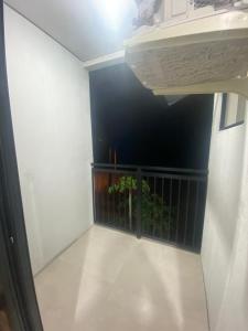 a hallway with a balcony with a plant at Pousada Vale das Bromelias Termas do Gravatal in Gravatal