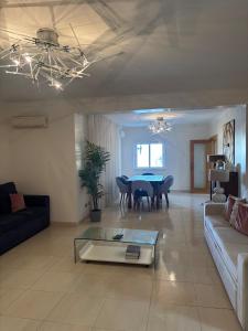 a living room with a couch and a table at Pool, BBQ & Soccer Villa in Aroeira
